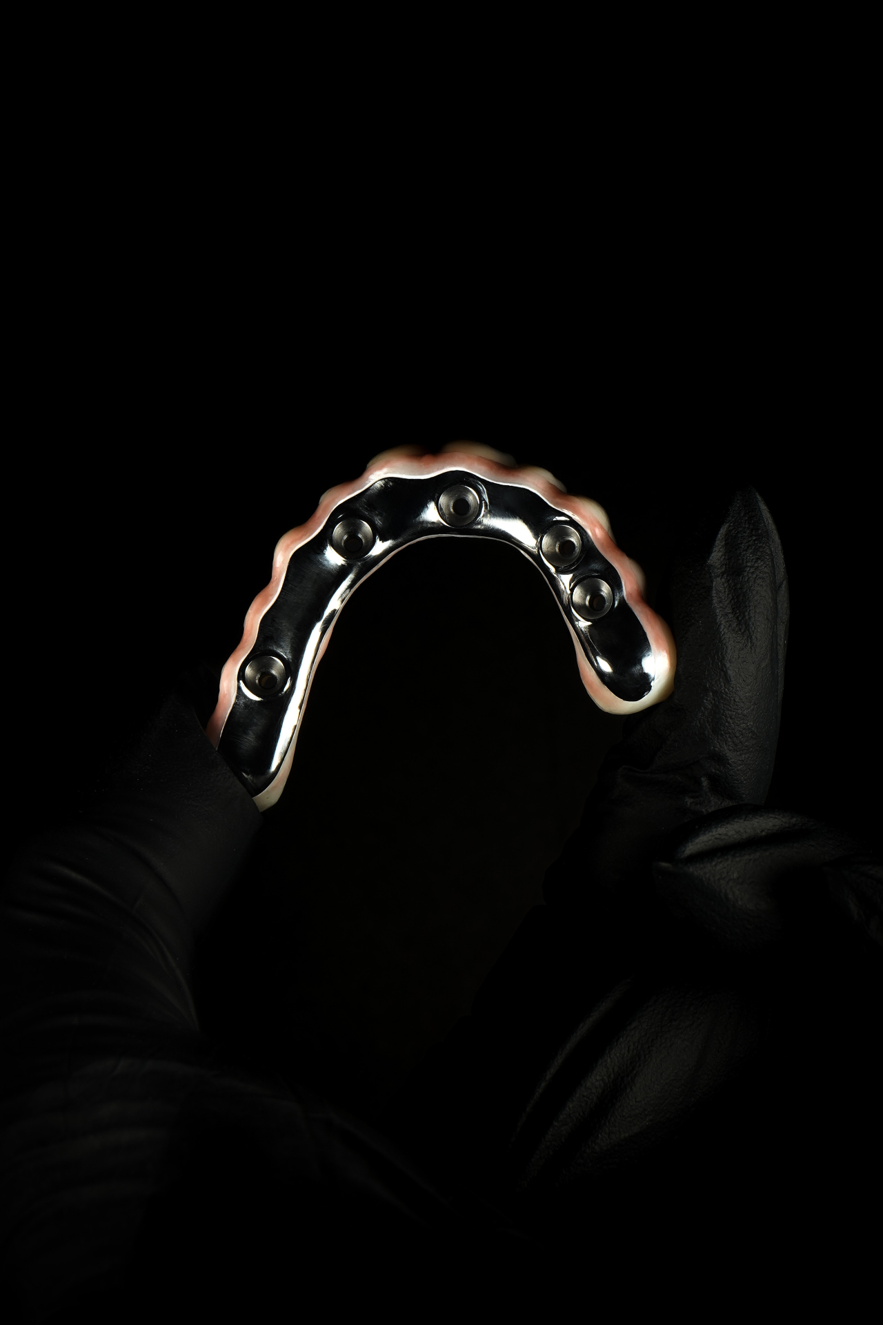 Titanium AOX framework in gloved hand